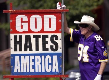 Fred Phelps Sr. of Westboro Baptist in Kansas displays one of his infamous protest signs, Photo by Capital-Journal File Photo/MBO